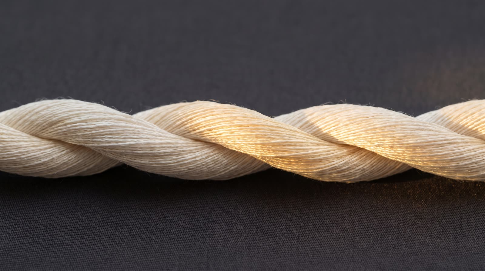 Two threads of ivory silk intertwining